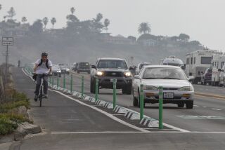 ENCINITAS , CA - JANUARY 05: Northbound bicyclists, riding along Highway 101, negotiate traffic and an intersection next to the Las Olas restaurant in in Cardiff by the Sea on Tuesday, Jan. 5, 2021 in Encinitas , CA. (Eduardo Contreras / The San Diego Union-Tribune)