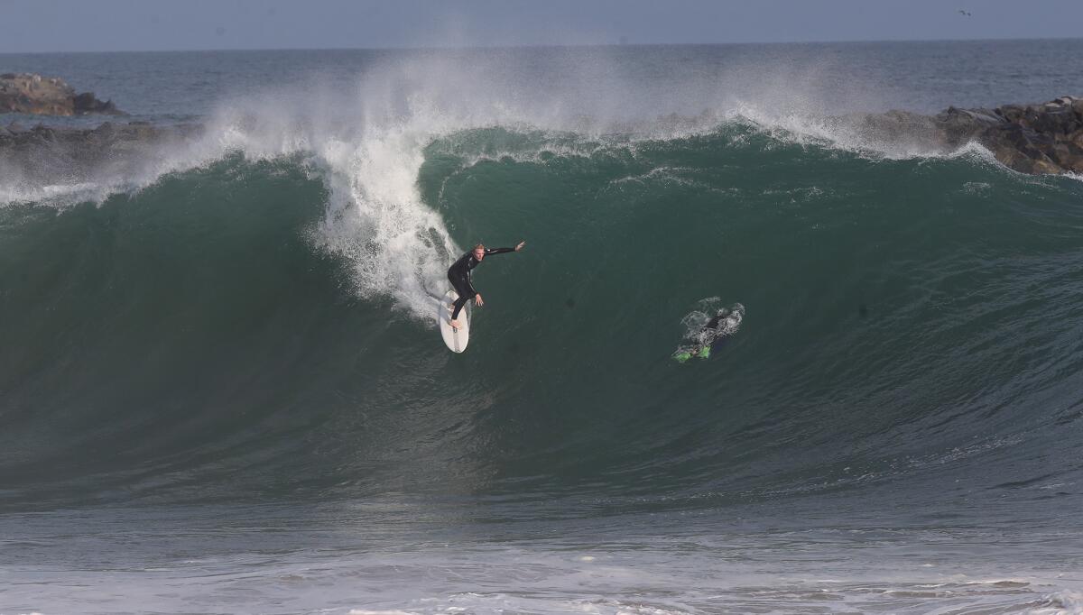 A surfer drops into a giant wave at the Wedge in Newport Beach in 2019.