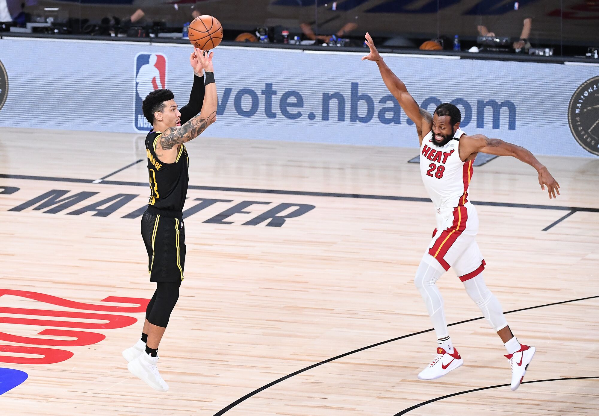 Lakers guard Danny Green misses a three-pointer in front of Miami Heat guard Andre Iguodala.