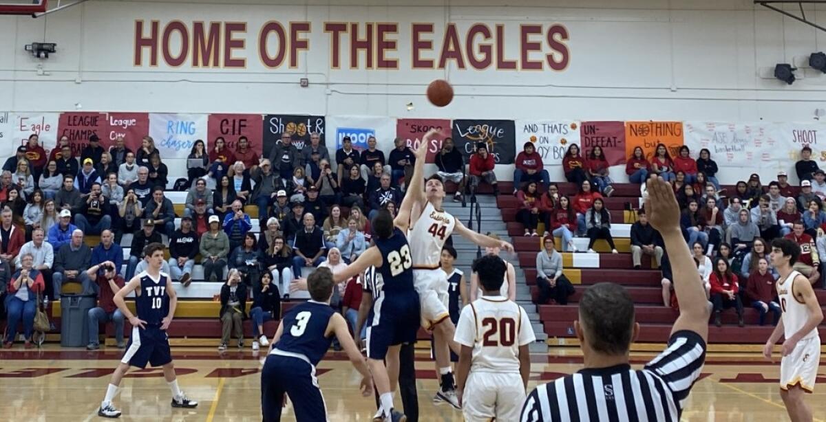 Estancia's Jake Covey (44) and Tarbut V'Torah's David Groner (23) go up for the opening tip in the CIF Southern Section Division 5AA first-round playoff game on Wednesday in Costa Mesa.