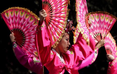 Korean American dancers perform a Fan Dance at the Pasadena celebration of the Chinese New Year. The revelers welcome the Year of the Boar, or pig, an animal from the Chinese zodiac considered to be lucky.