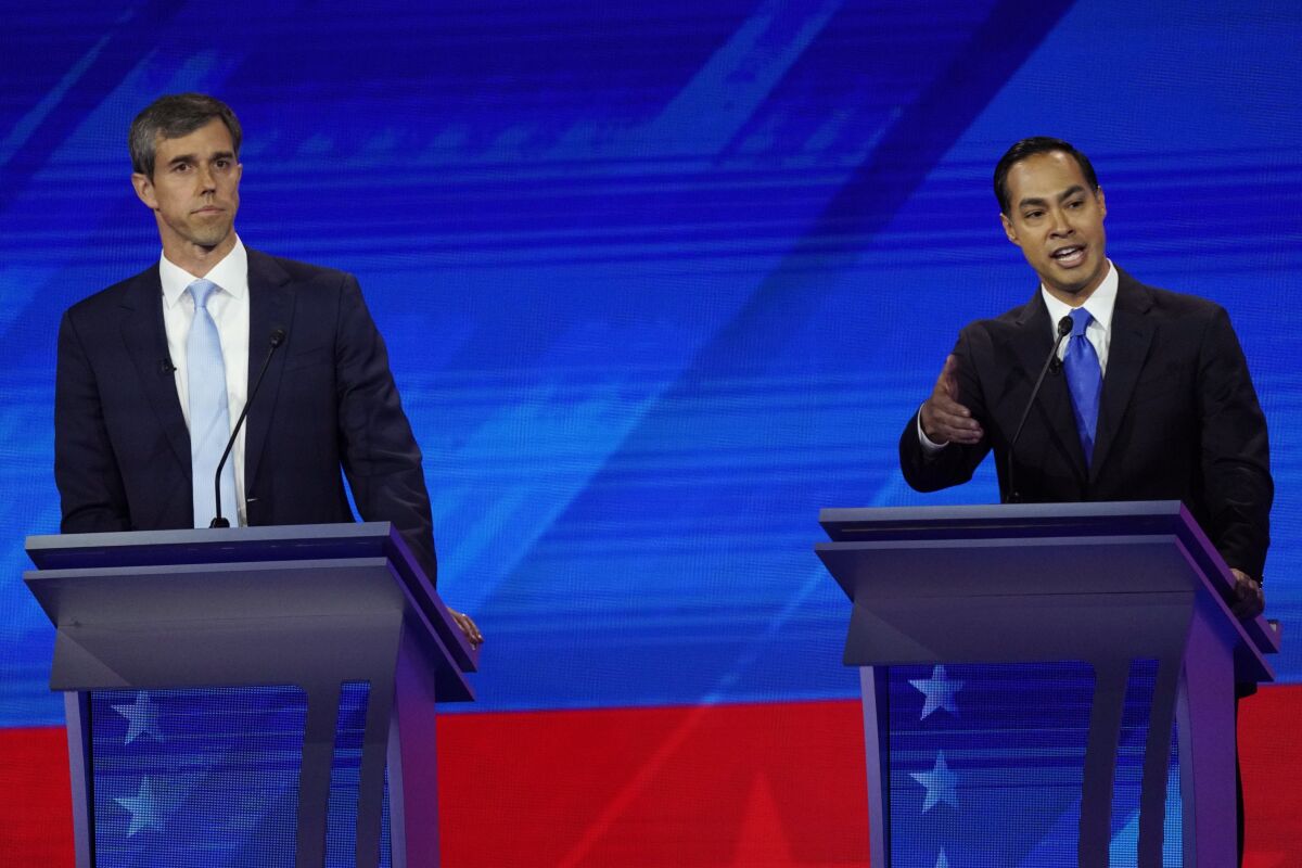 Former Texas Rep. Beto O'Rourke, left, listens as former Housing and Urban Development Secretary Julián Castro answers a question during the Democratic presidential primary debate in Houston.