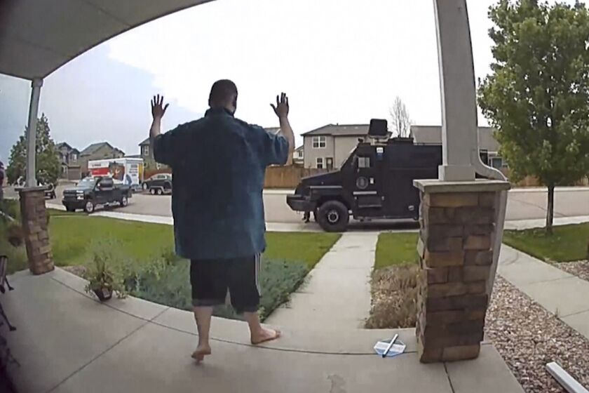 In this image from video provided by Leslie Bowman, Anderson Lee Aldrich surrenders to police at a home where his mother, Laura Voepel, was renting a room in Colorado Springs, Colo., on June 18, 2021. According to sealed law enforcement documents verified by The Associated Press, Aldrich's actions brought SWAT teams and the bomb squad to the normally quiet neighborhood, forced the grandparents to flee for their lives and prompted the evacuation of 10 nearby homes to escape a possible bomb blast. (Leslie Bowman via AP)