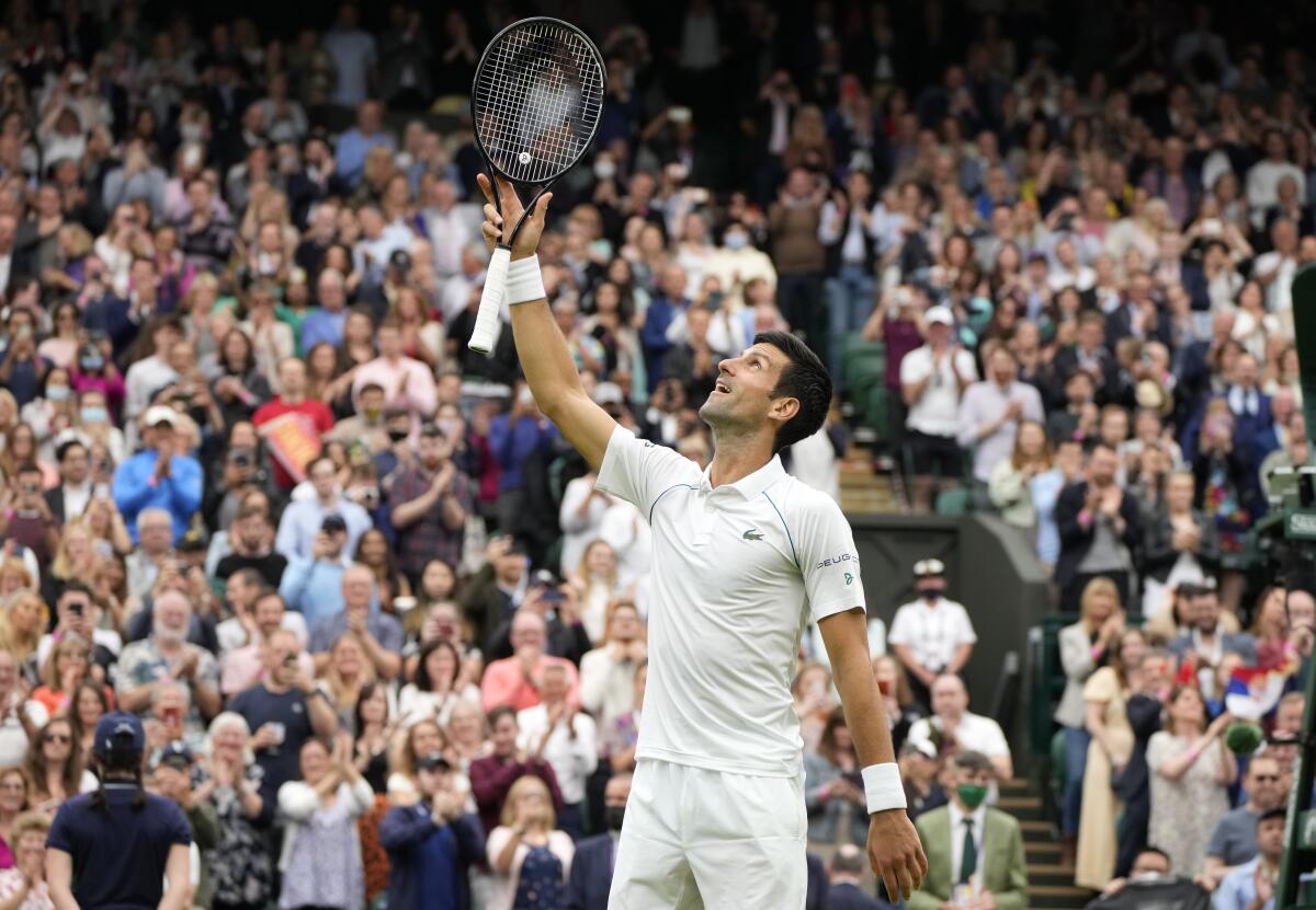 Novak Djokovic celebrates winning the first round men's singles match against Jack Draper.