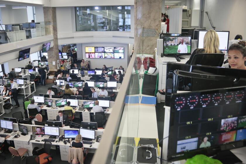 Staffers work in the Al Jazeera America newsroom after the network's first broadcast in New York. The Qatar-based Al Jazeera Media Network issued a statement in response to a complaint filed by prior owners of Current TV, former Vice President Al Gore and his business partner Joel Hyatt.