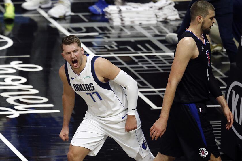 Mavericks guard Luka Doncic (77) reacts after dunking against Clippers center Ivica Zubac on May 25, 2021 in Los Angeles.