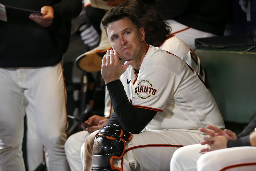 San Francisco Giants' Buster Posey sits in the dugout during the eighth inning of Game 2 of a baseball National League Division Series against the Los Angeles Dodgers Saturday, Oct. 9, 2021, in San Francisco. (AP Photo/Jed Jacobsohn)