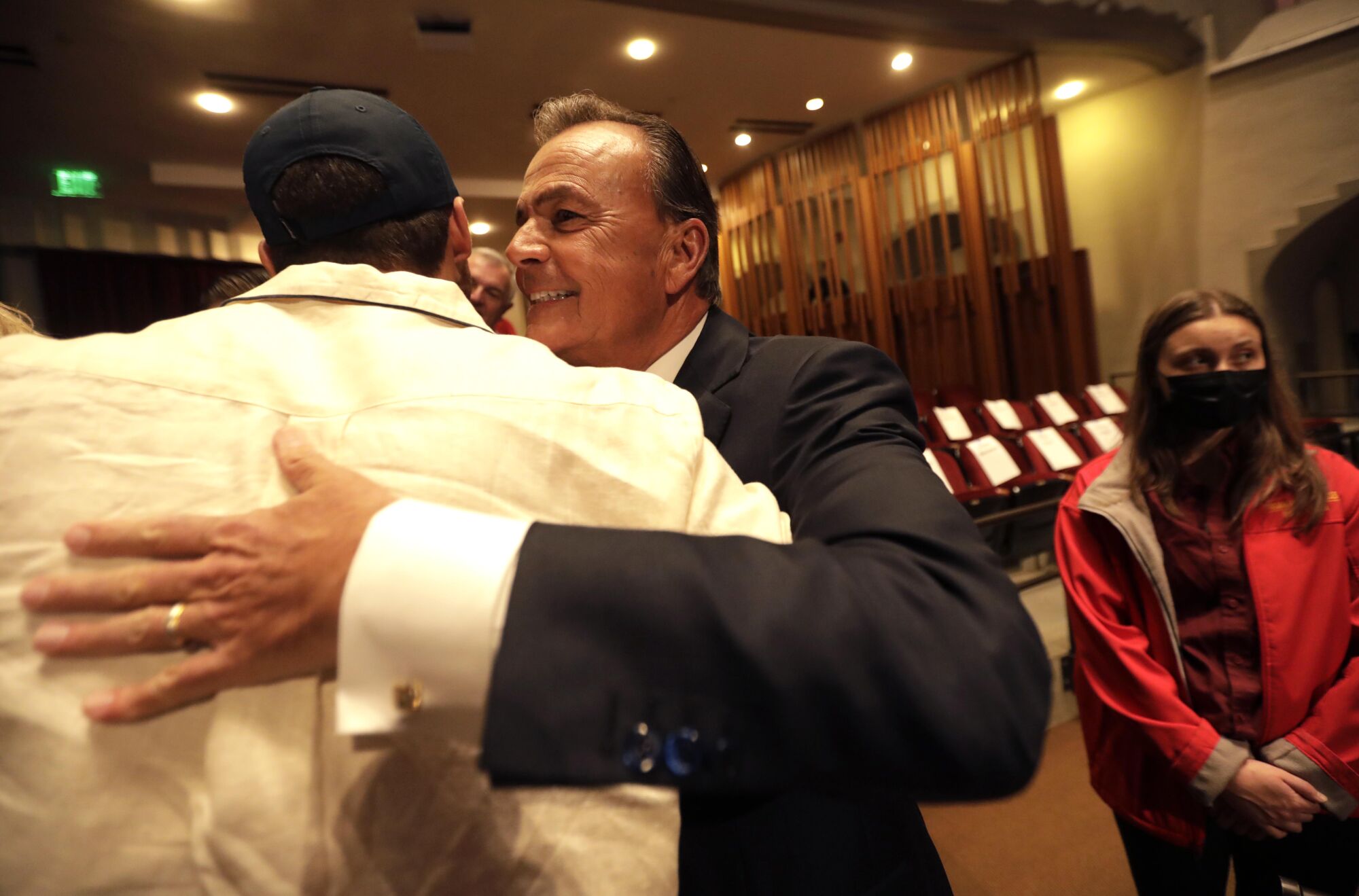 Rick Caruso hugs a supporter before the debate.