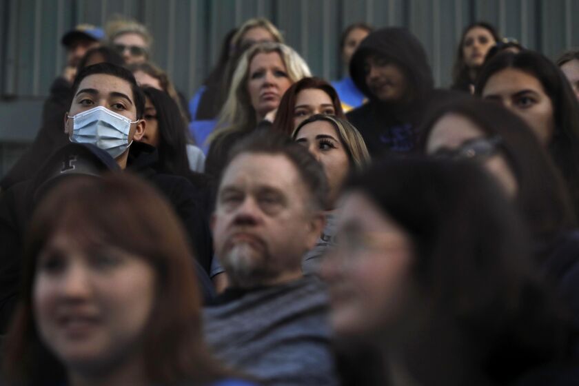LOS ANGELES, CA - APRIL 29, 2022 - - Only one fan in this section wears a mask while watching UCLA's women's softball team play a game against Utah at Easton Stadium on the UCLA campus on April 29, 2022. (Genaro Molina / Los Angeles Times)
