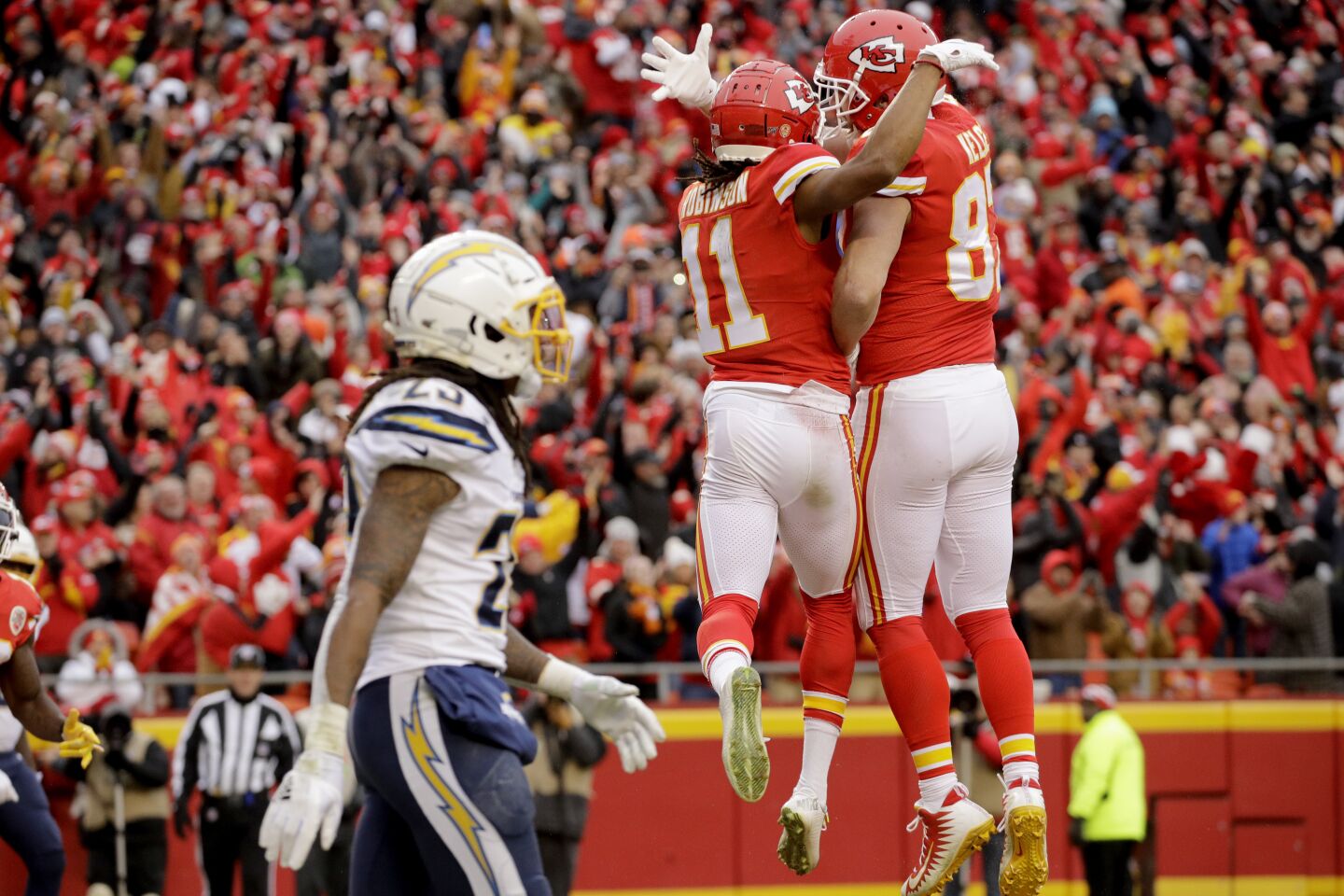 Chiefs receiver Demarcus Robinson (11) celebrates a touchdown with tight end Travis Kelce (87) as Chargers safety Rayshawn Jenkins looks on during a game Sunday.