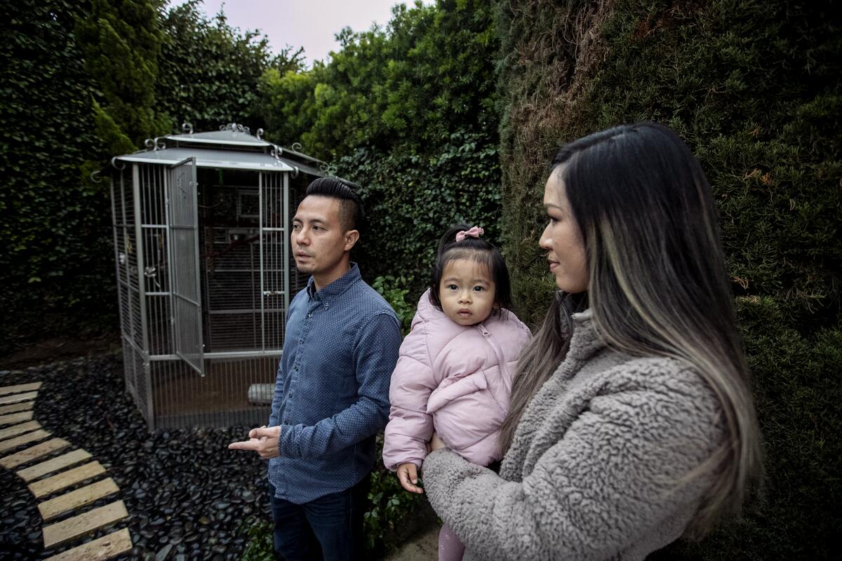 Fountain Valley's John Nguyen with wife Dina Vu and daughter Hailey have been looking for their African grey parrot, Smokey.