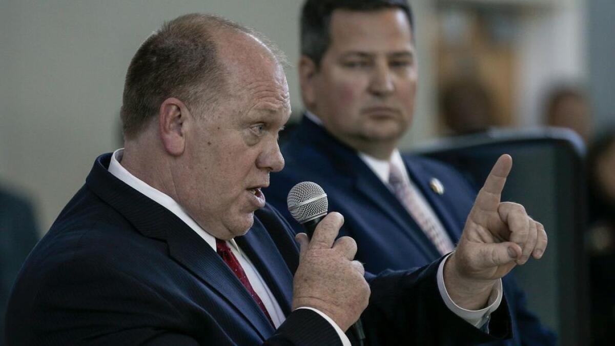 Hundreds of Sacramento residents protested, listened and shouted while acting ICE Director Thomas Homan, left, and Sacramento County Sheriff Scott Jones held a community forum in March.
