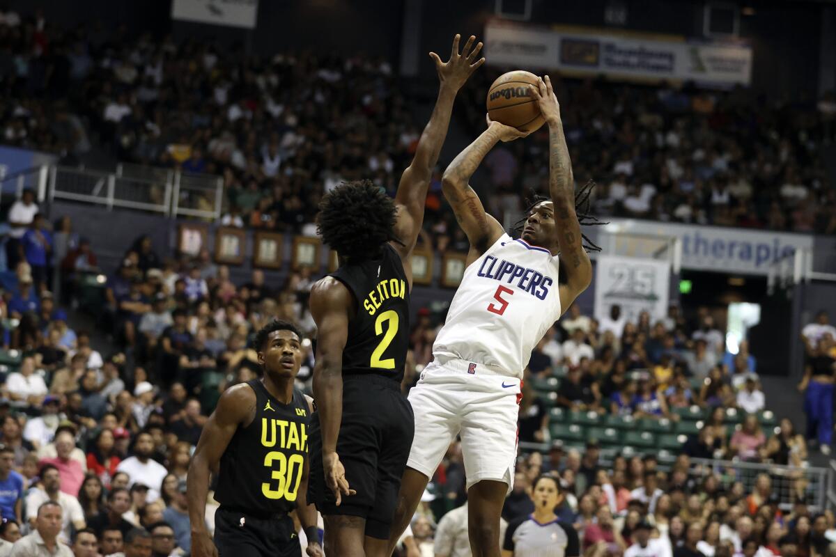 Clippers guard Bones Hyland pulls up in the lane for a jump shot over Jazz guard Collin Sexton.