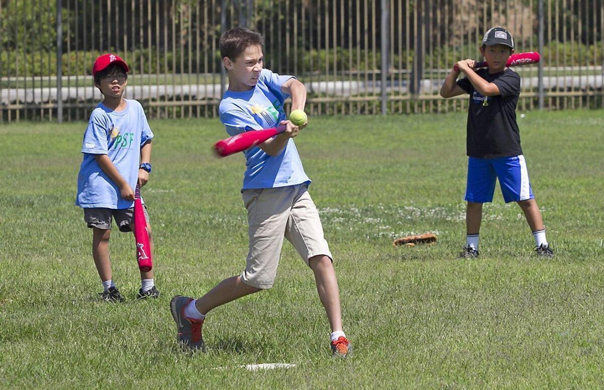 A student in the Science of Baseball class takes a swing for a home run at Stonegate Elementary in Irvine on Thursday.