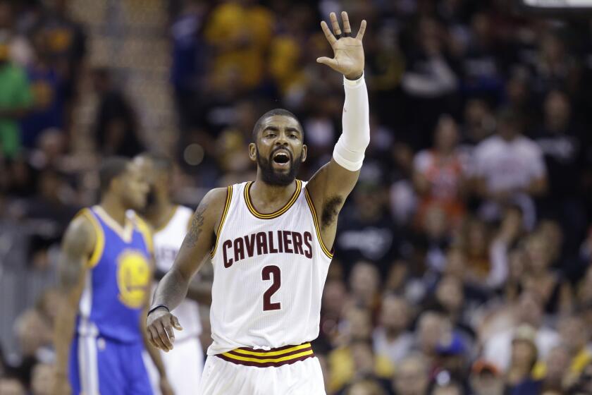 Cavaliers guard Kyrie Irving reacts after a play during the first half.