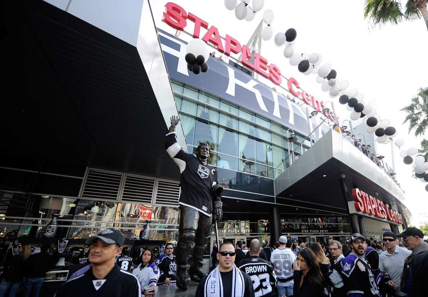 Kings fans mingle in front of a statue of hockey great Wayne Gretzky outside of Staples Center before Thursday's playoff game against the Phoenix Coyotes.