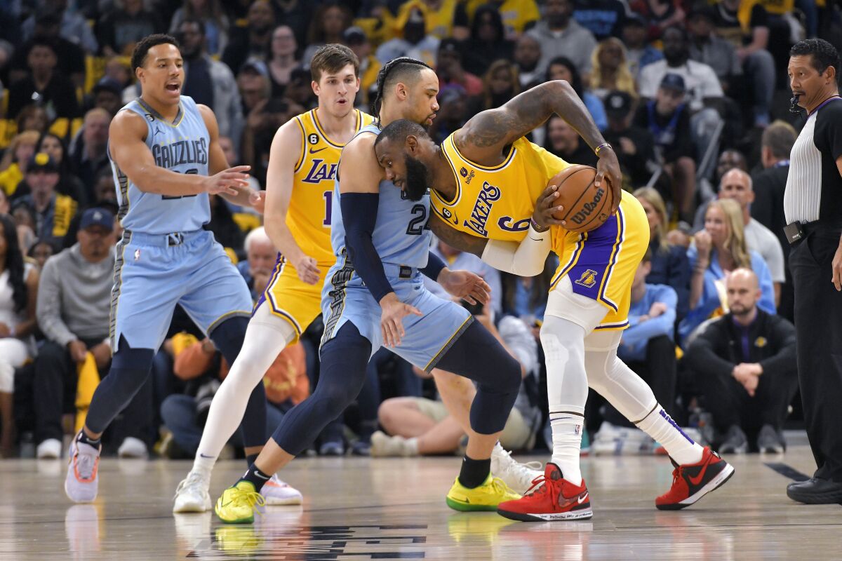 Lakers forward LeBron James is defended by Memphis Grizzlies forward Dillon Brooks.
