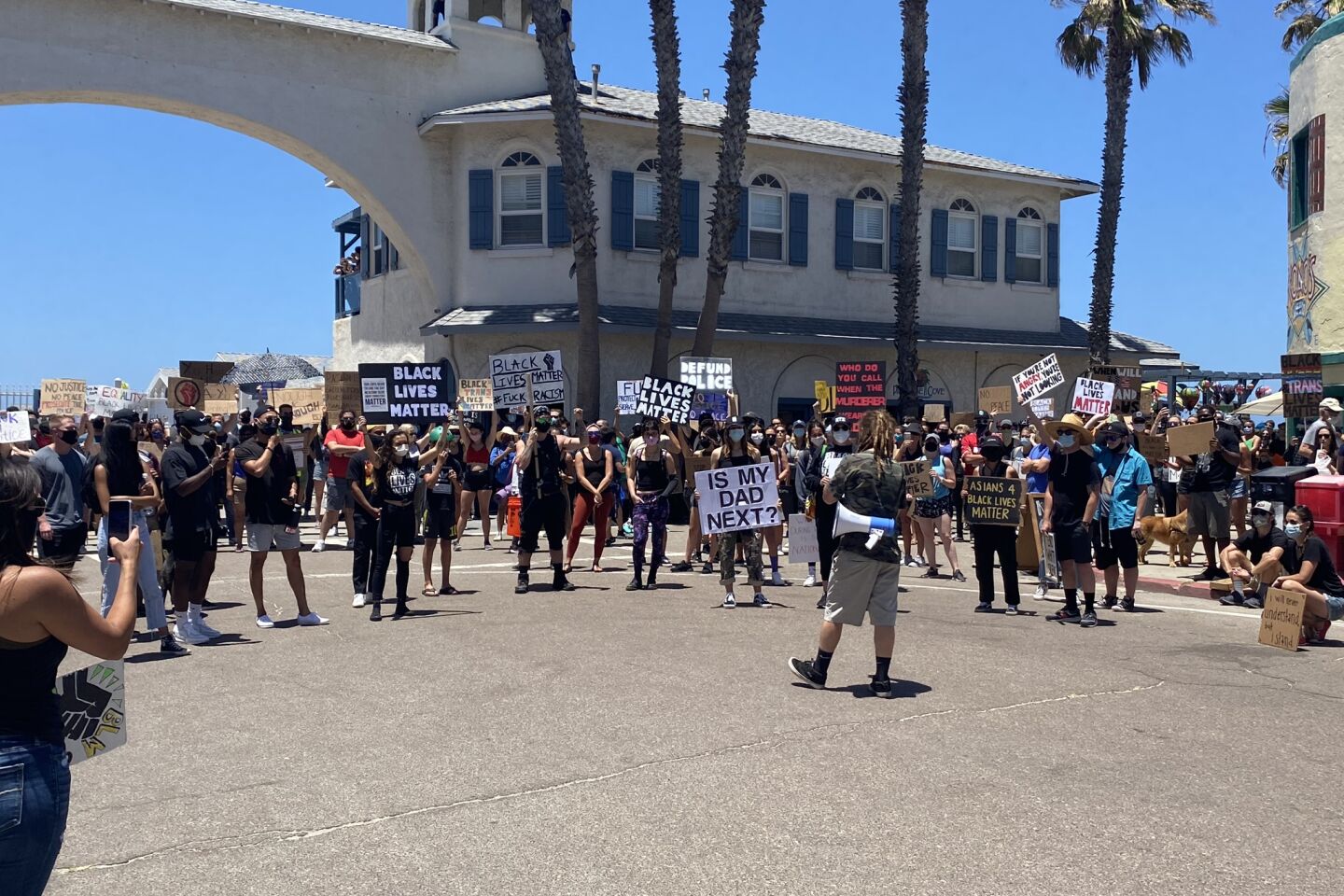 Demonstrators gather near the Crystal Pier for the Pacific Beach Walk for Equality on June 14.