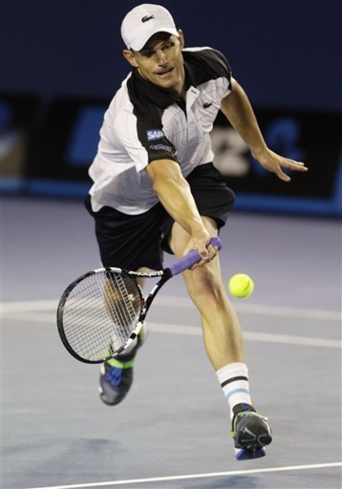 Andy Roddick of the US reaches for a forehand return to Australia's Lleyton Hewitt during their second round match at the Australian Open tennis championship, in Melbourne, Australia, Thursday, Jan. 19, 2012. (AP Photo/John Donegan)