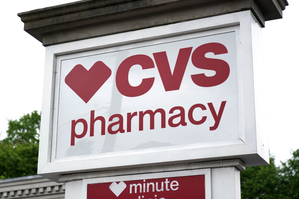 This is a CVS Pharmacy sign is shown in Mount Lebanon, Pa., on Monday May 3, 2021. CVS Health delivered a better-than-expected third quarter, Wednesday, Nov. 3, 2021, and raised its 2021 forecast again as customers returned to its drugstores for prescriptions or COVID-19 vaccinations. (AP Photo/Gene J. Puskar)