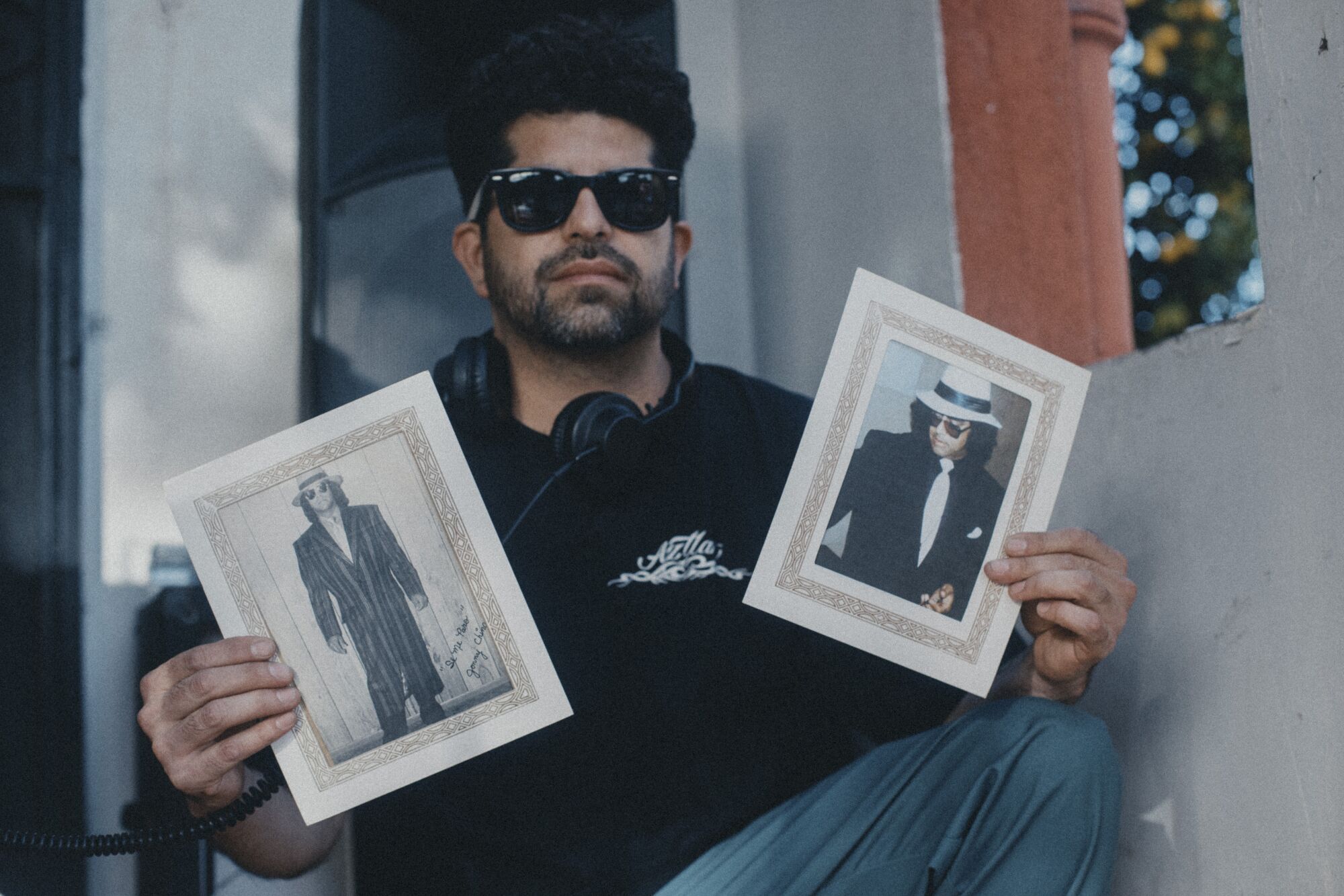 Artist, DJ Gary "Ganas" Garay holds photos of Jonny Chingas, the late L.A. legend.