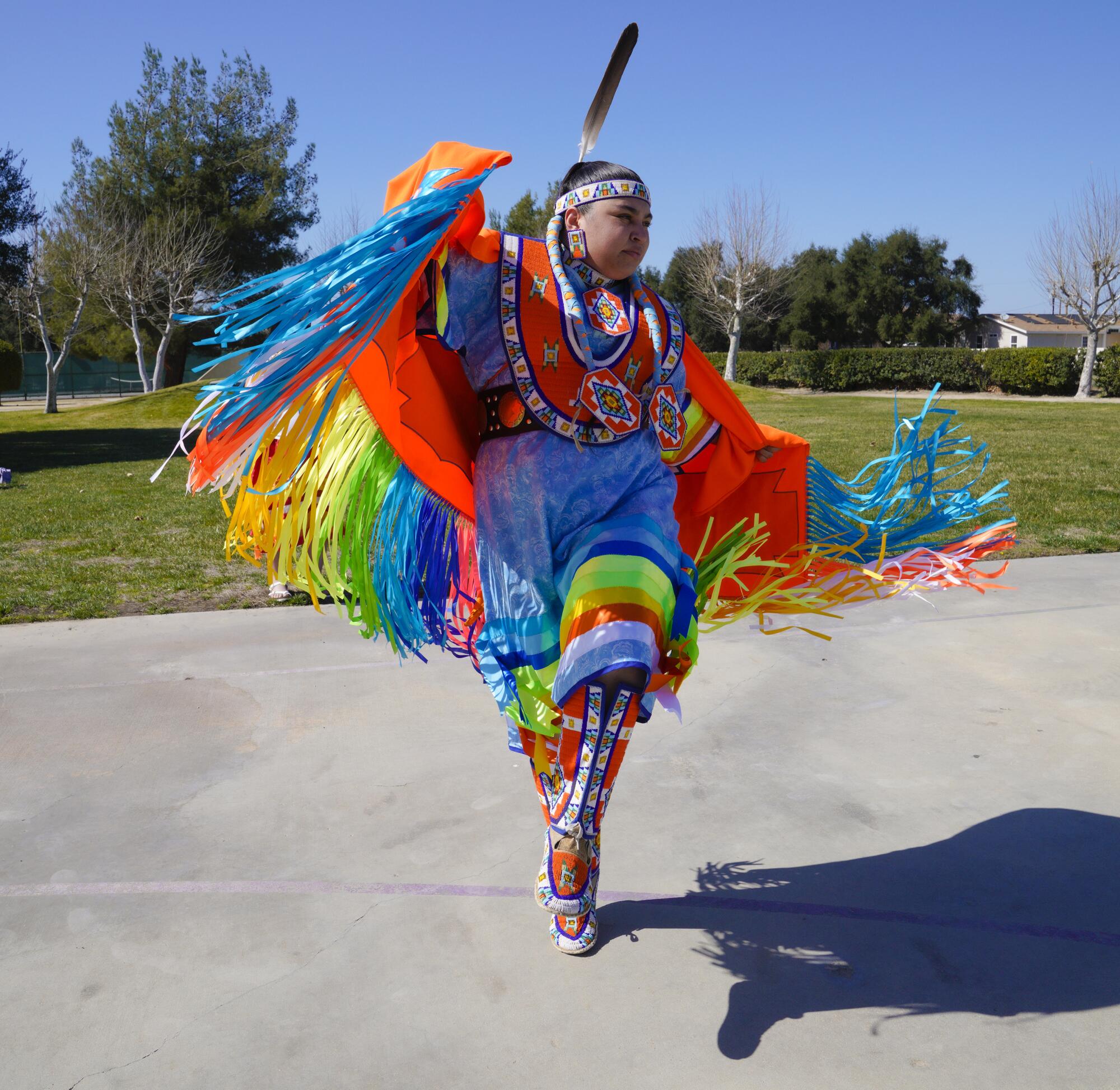 Powwow dancer in a multicolored costume