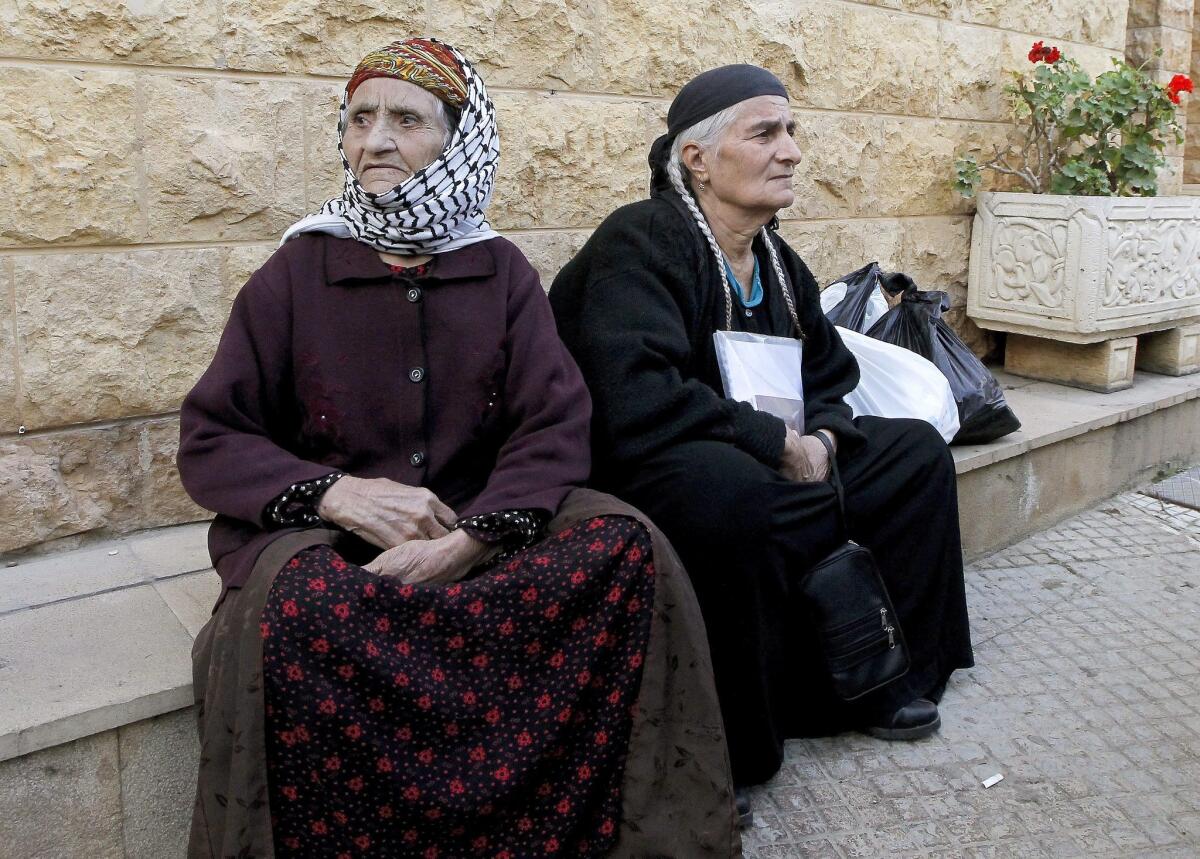 Two Chaldean Christian women, among the estimated 30,000 Christians who have fled Iraq and Syria because of Islamic State violence, wait in Lebanon for help.