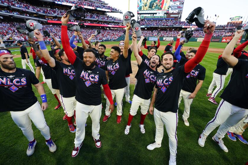 The Philadelphia Phillies pose in NLCS T-shirts after they defeated Atlanta Braves on Oct. 15, 2022.