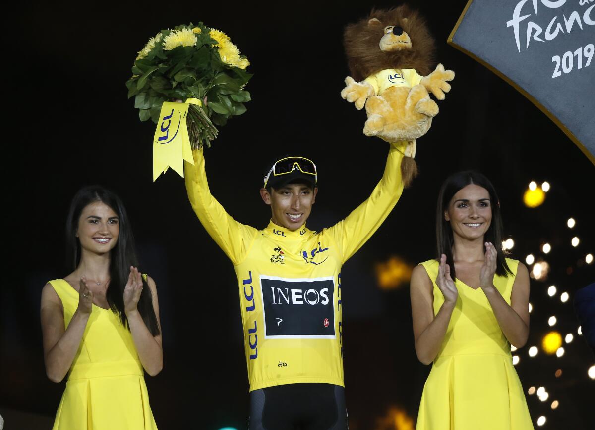 Egan Bernal stands on the podium in Paris after winning the 2019 Tour de France.