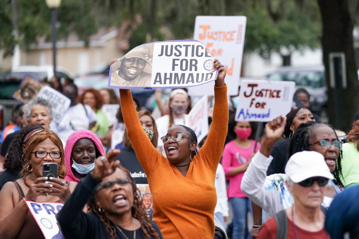 Demonstrators march outside the Glynn County Courthouse in Brunswick, Ga. 