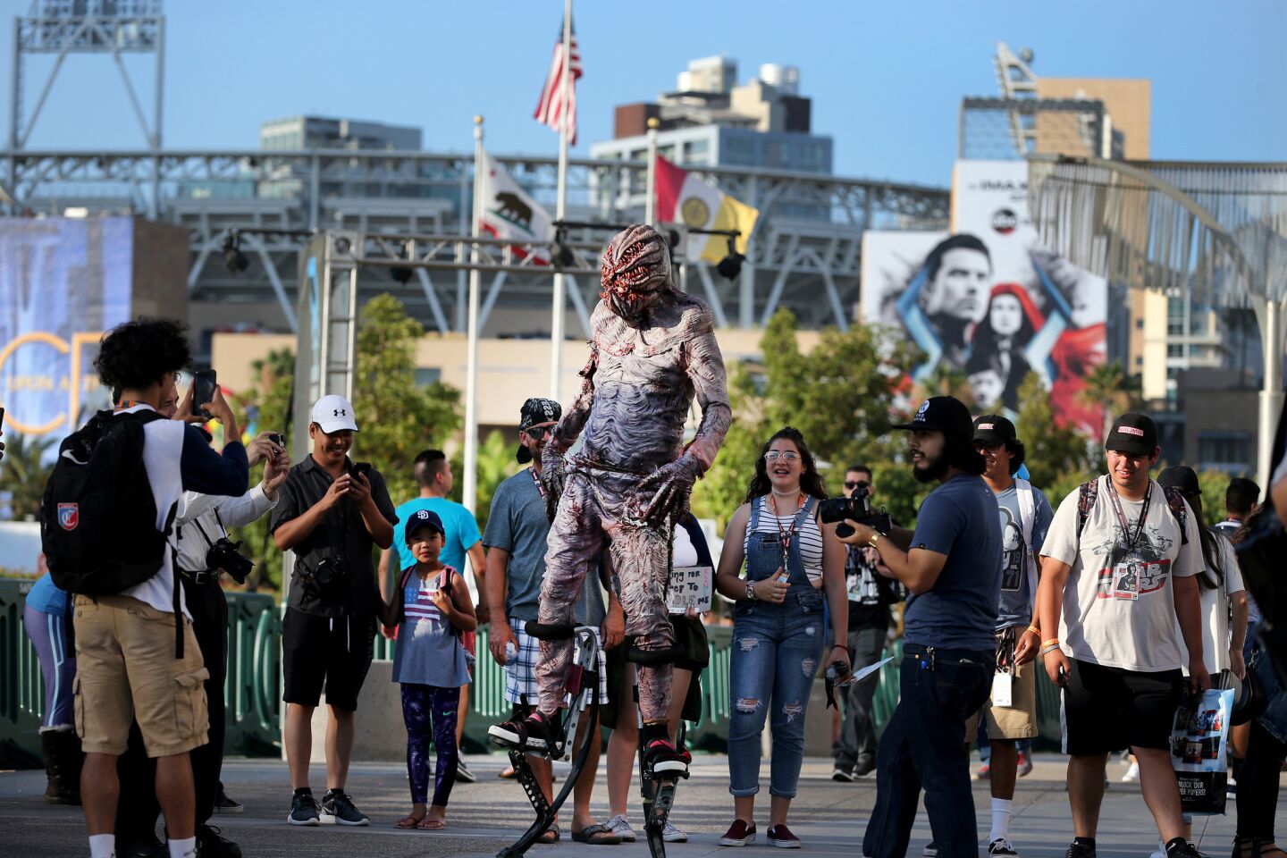 A costumed character on stilts walks around the San Diego Convention Center on opening day of Comic-Con International.