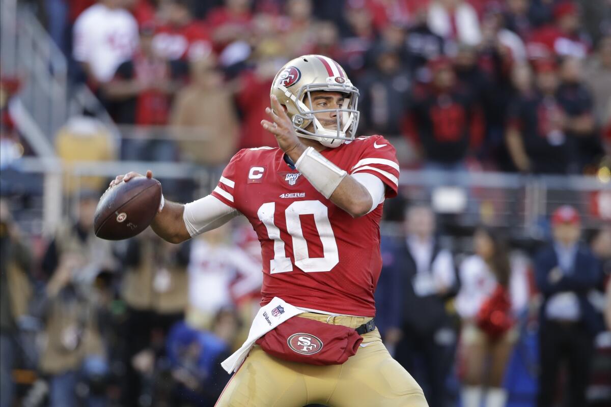 Quarterback Jimmy Garoppolo (10) looks to pass against the Vikings during the first half of an NFL divisional playoff game Jan. 11 at Levi's Stadium.