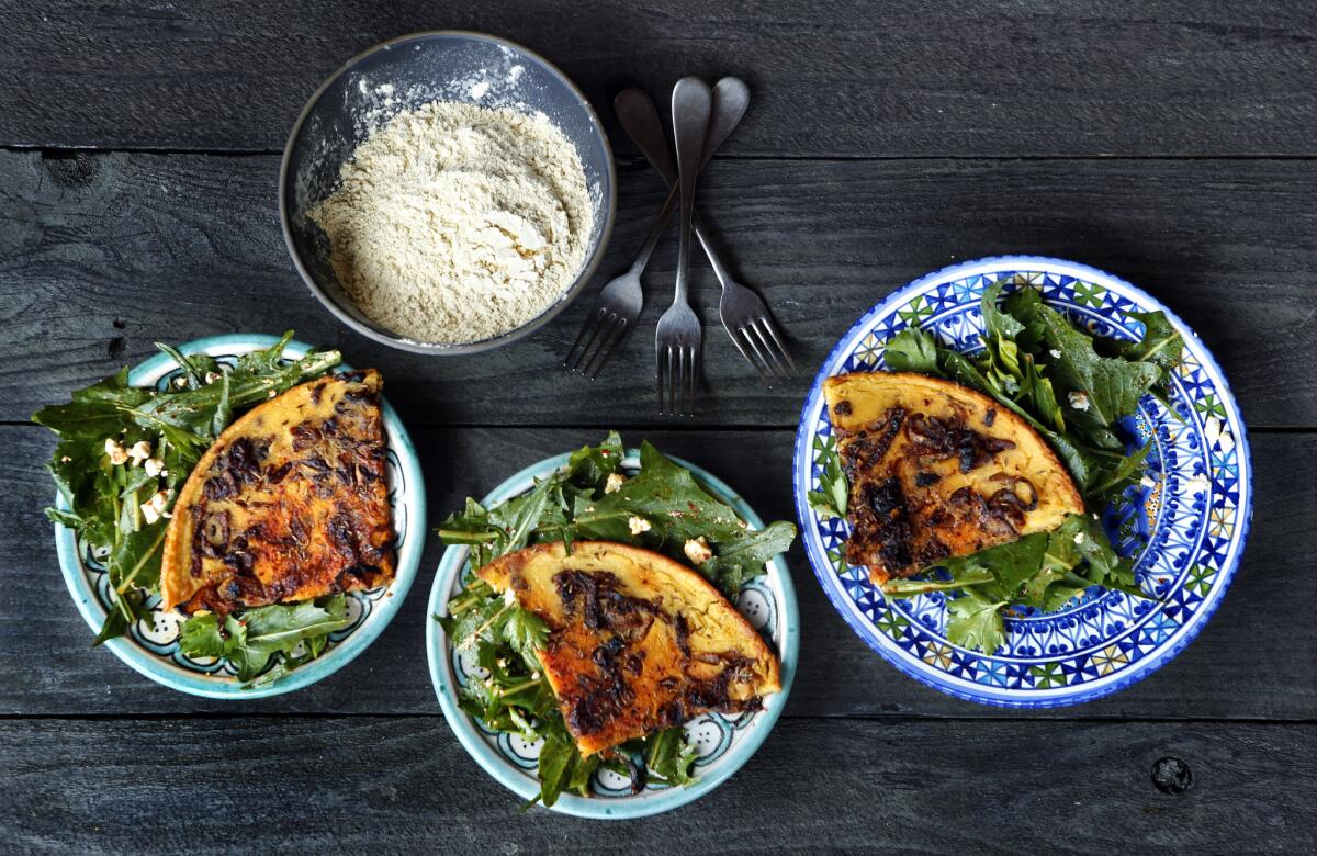 North African chickpea pancakes with harissa tossed bitter greens.