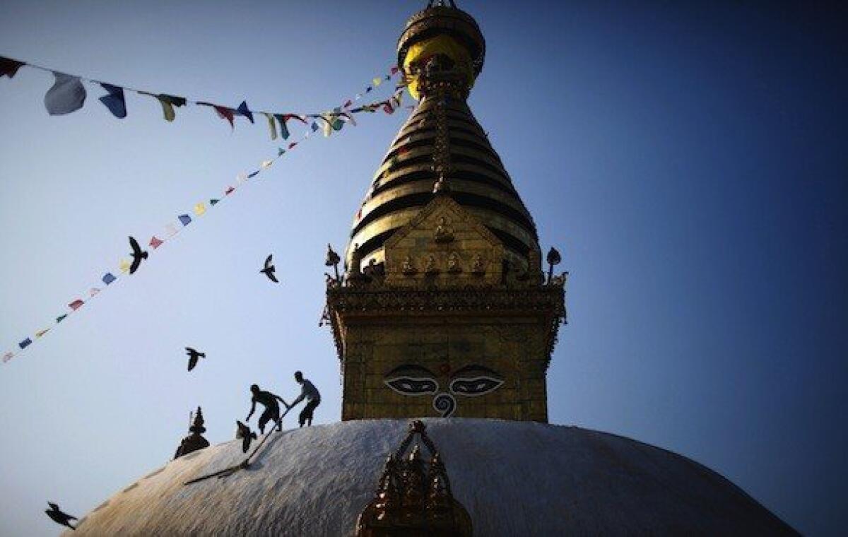 The Swayambhunath stupa or temple on a hill in Kathmandu receives a touch-up. It's one of the stops on a volunteer trip organized by United Planet.