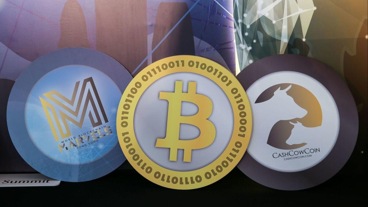 Logos of cryptocurrencies are displayed during the World Blockchain Marvels summit in Hong Kong last month.