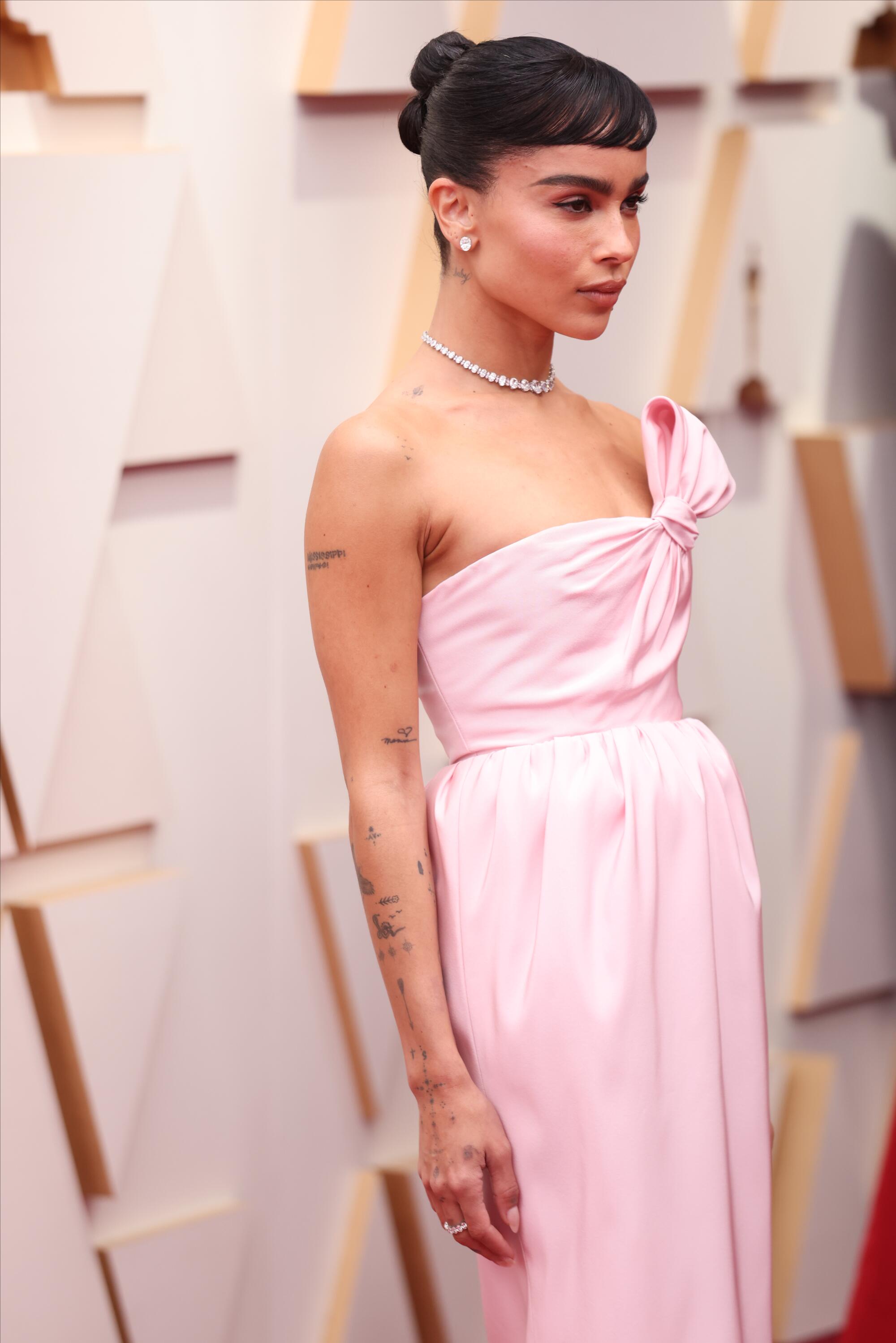 A woman shows off her gown at the Academy Awards.