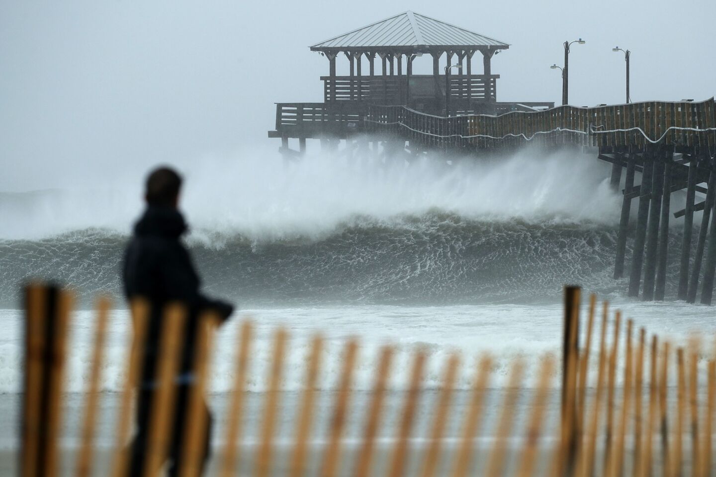 ATLANTIC BEACH, NC - SEPTEMBER 13: Waves crash underneath the Oceana Pier as the outer bands of Hurricane Florence being to affect the coast September 13, 2018 in Atlantic Beach, United States. Coastal cities in North Carolina, South Carolina and Virginia are under evacuation orders as the Category 2 hurricane approaches the United States.