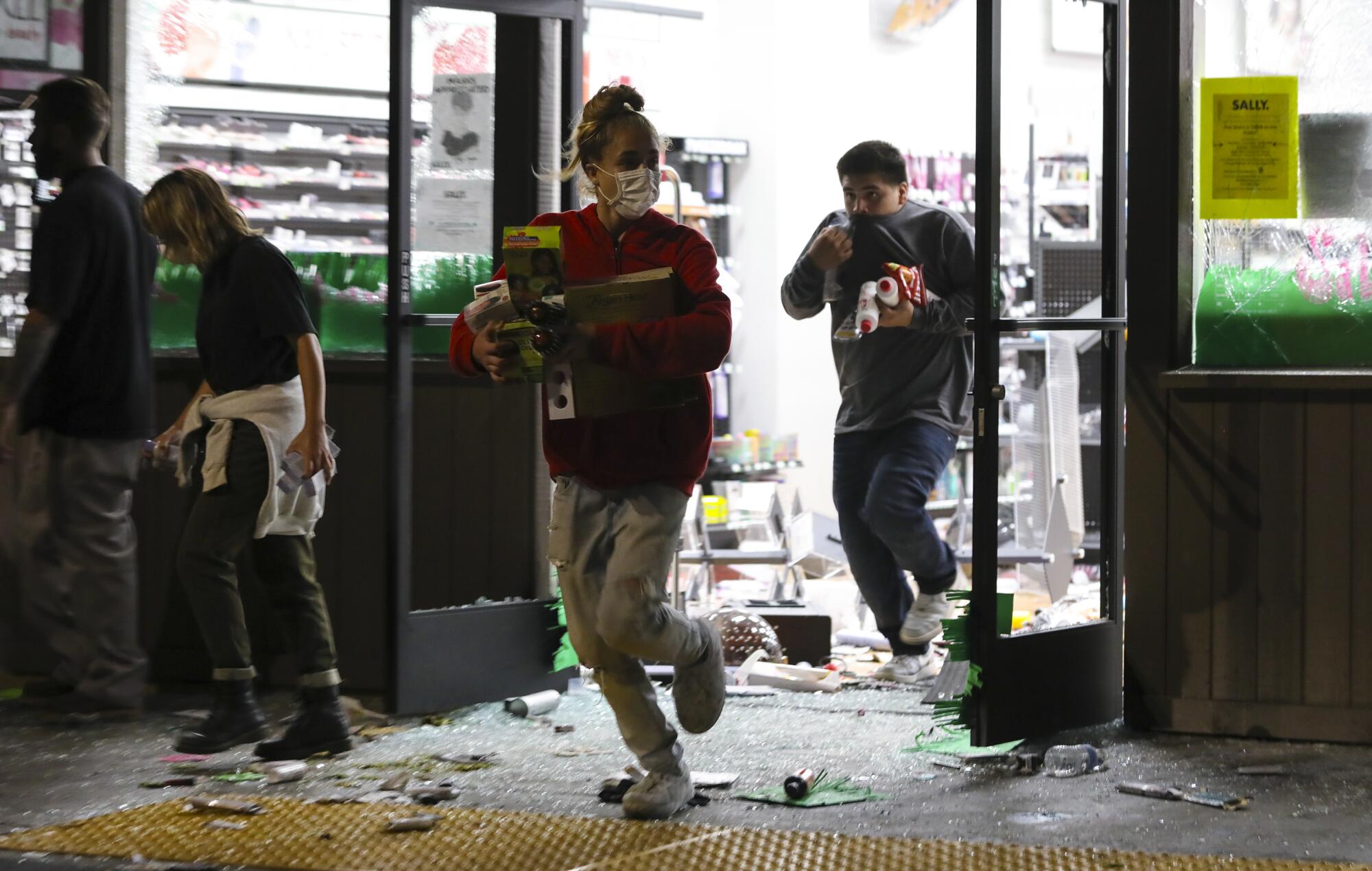 By nightfall on Saturday, looters had smashed windows and taken items from a number of retail stores at the La Mesa Springs shopping center.