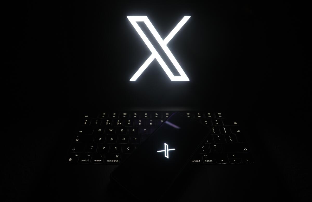 The logo of X, formerly Twitter, is displayed on screens.