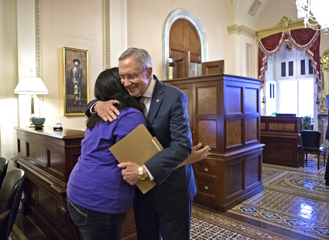 Reid embraces Silva at the Capitol on June 27, 2013. He carries a folder with letters from her that he read on the Senate floor before the historic vote on immigration reform.