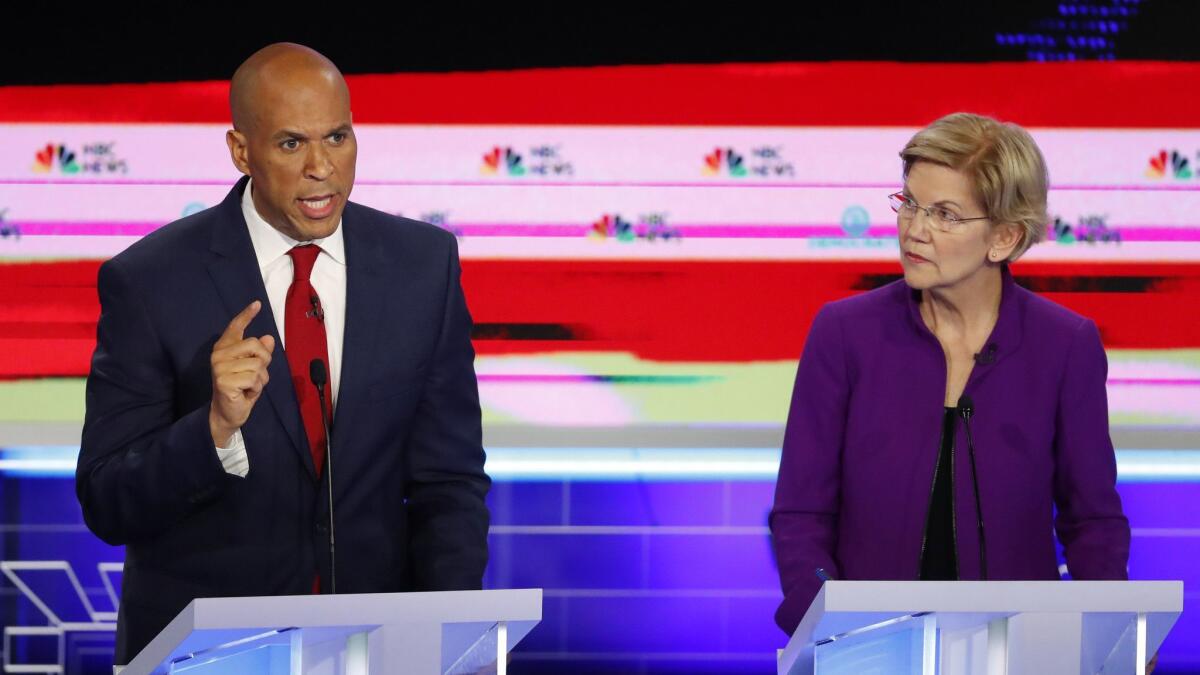 Democratic presidential candidate Sen. Cory Booker, D-N.J., speaks during the Democratic primary debate on Wednesday in Miami. To the right is Sen. Elizabeth Warren, D-Mass.