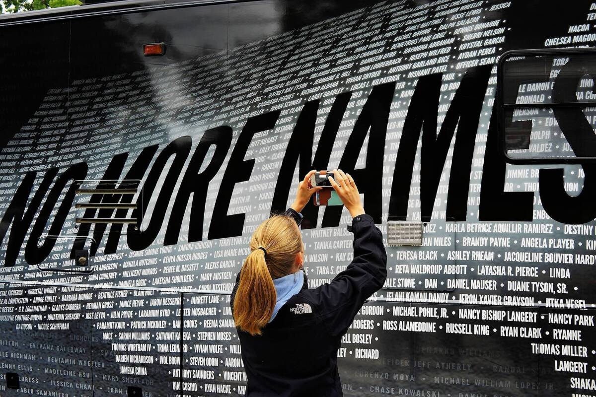 A bus bears some of the more than 6,000 names of people killed by gun violence since the massacre in Newtown at a remembrance event on the six month anniversary of the massacre at Sandy Hook Elementary School.