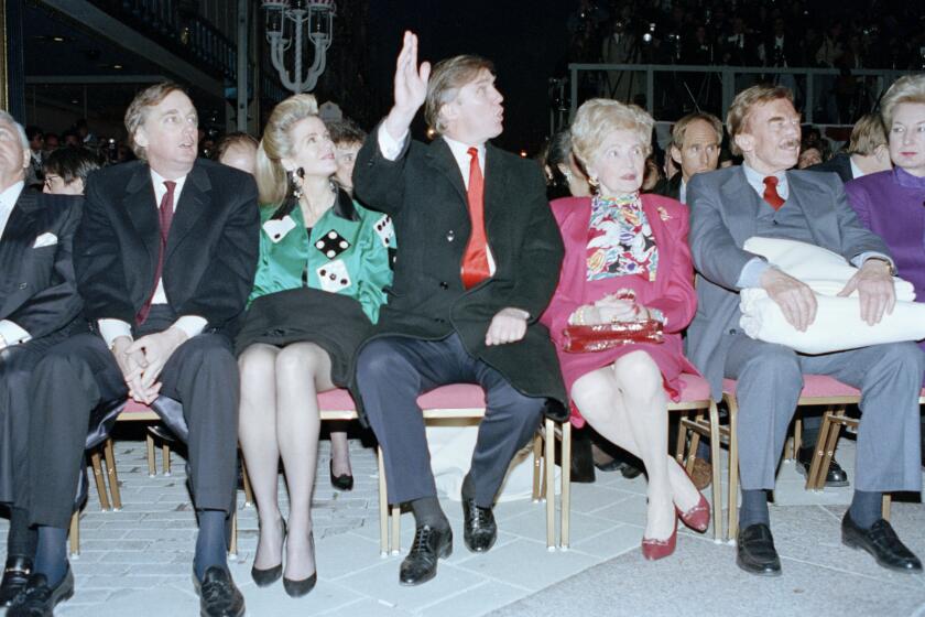 Donald Trump waves to staff members of the Trump Taj Mahal Casino Resort as they cheer him on before the start of the grand opening ceremonies in Atlantic City, N.J., Thursday night on April 5, 1990. Trump attended the gala with his mother, Mary, father, Fred, and sister, the U.S. District Court Judge Maryanne Trump Barry, right. On the left is Donald Trump's brother Robert Trump and his wife Blaine Trump. (AP Photo/Charles Rex Arbogast)