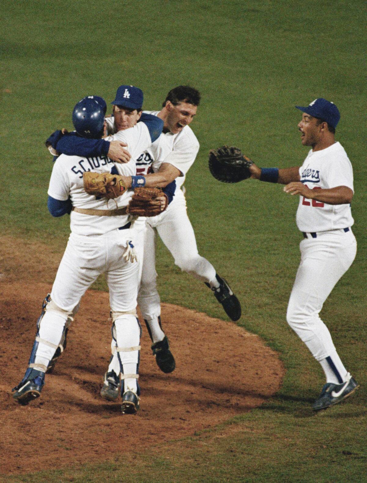 Dodgers pitcher Orel Hershiser, top left, celebrates with catcher Mike Scioscia and teammates Steve Sax and Franklin Stubbs.