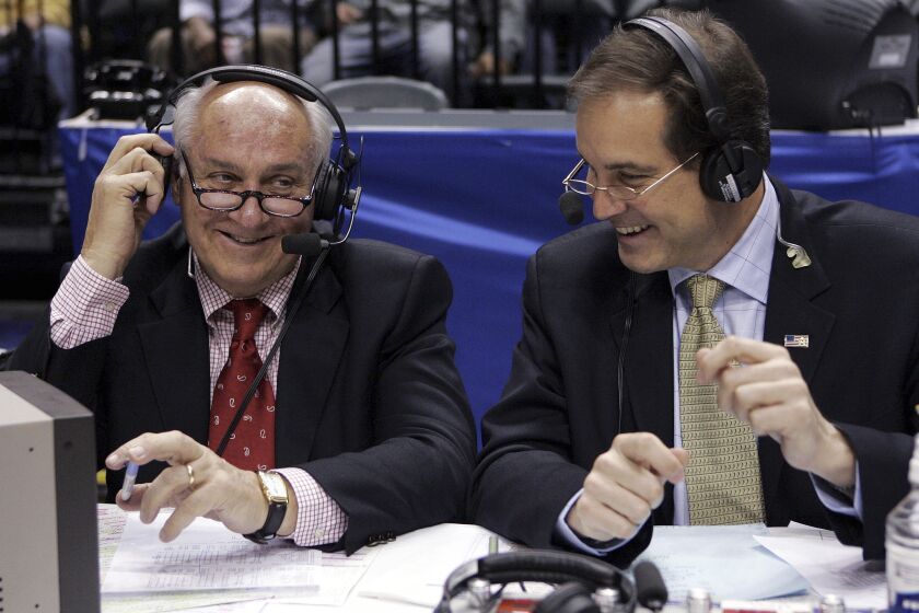 FILE - CBS announcers Billy Packer, left, and Jim Nantz laugh during a break in the championship game in the Big Ten basketball tournament in Indianapolis, March 12, 2006. Packer, an Emmy award-winning college basketball broadcaster who covered 34 Final Fours for NBC and CBS, died Thursday night, Jan. 26, 2023. He was 82. Packer's son, Mark, told The Associated Press that his father had been hospitalized in Charlotte, N.C., for the past three weeks and had several medical issues, and ultimately succumbed to kidney failure. (AP Photo/Michael Conroy, File)