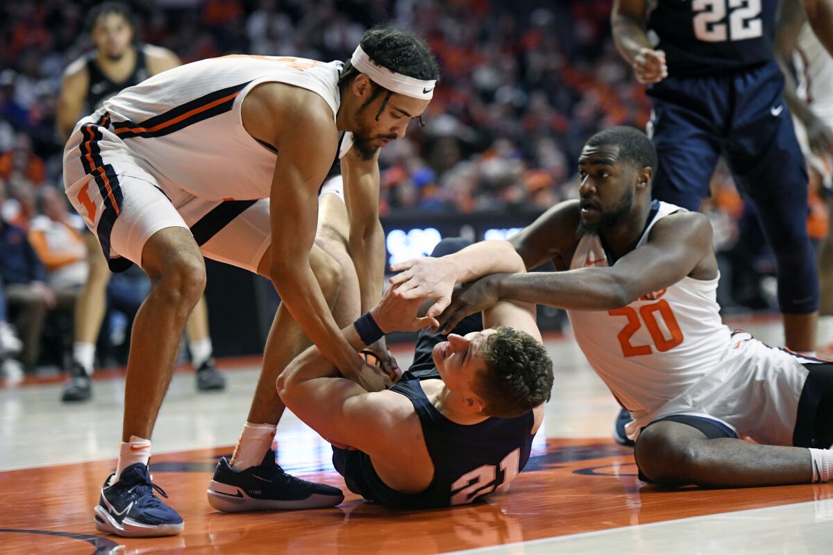 Penn State's John Harrar (21) calls timeout as he vies for a loose ball against Illinois' Da'Monte Williams (20) and Jacob Grandison during the second half of an NCAA college basketball game Thursday, March 3, 2022, in Champaign, Ill. (AP Photo/Michael Allio)