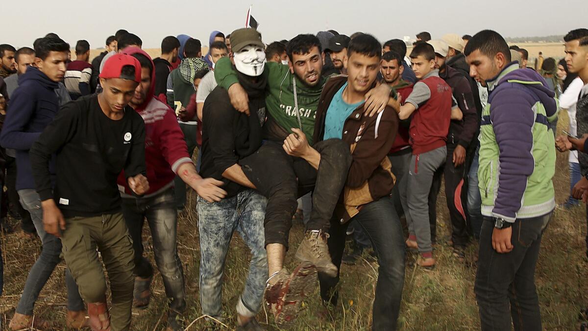 Palestinian protesters evacuate a wounded youth during clashes with Israeli troops along Gaza's border with Israel on April 5.