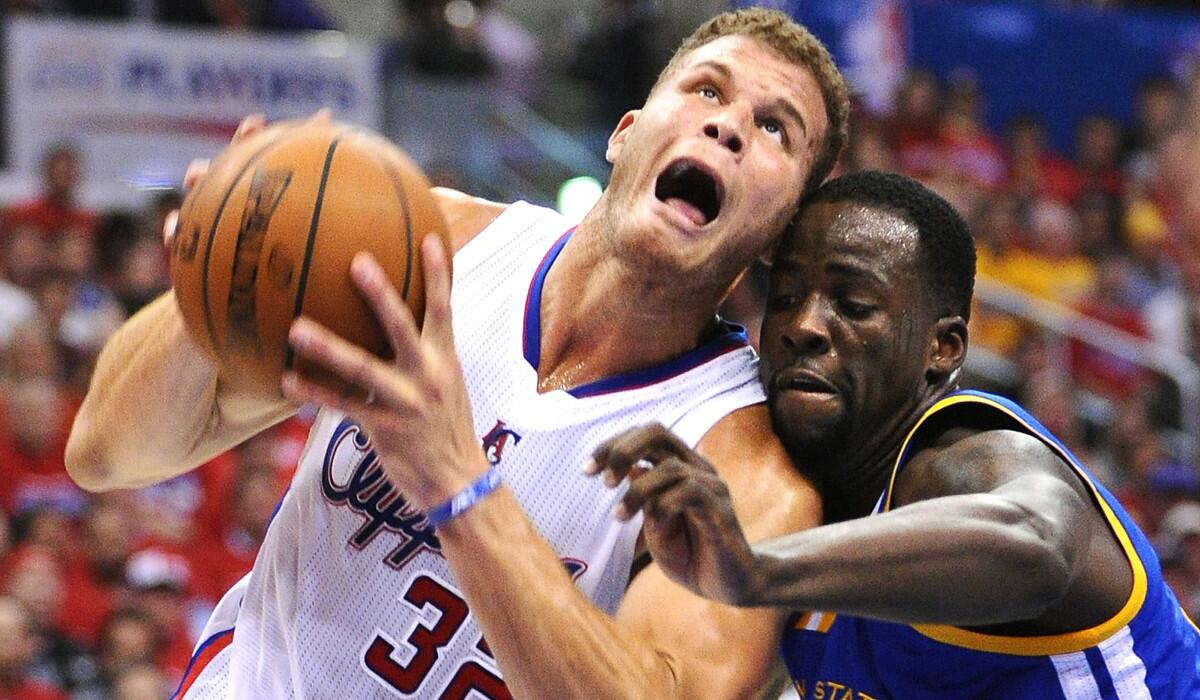 Clippers power forward Blake Griffin is fouled by Warriors power forward Draymond Green on a drive in the first quarter Saturady night at Staples Center.