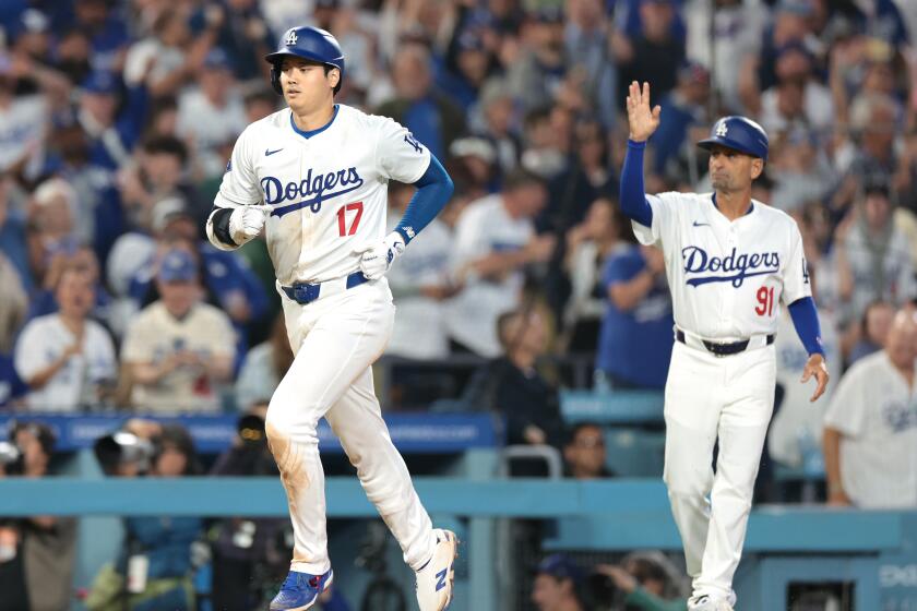 The Dodgers' Shohei Ohtani rounds the bases after hitting a two-run home run against the Rangers 