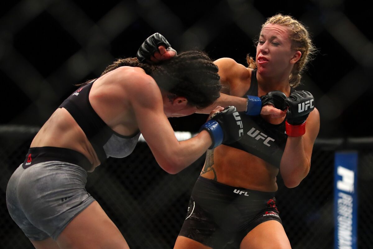 Angela Magana tries to evade a punch thrown by Amanda Cooper during their fight at UFC 218.